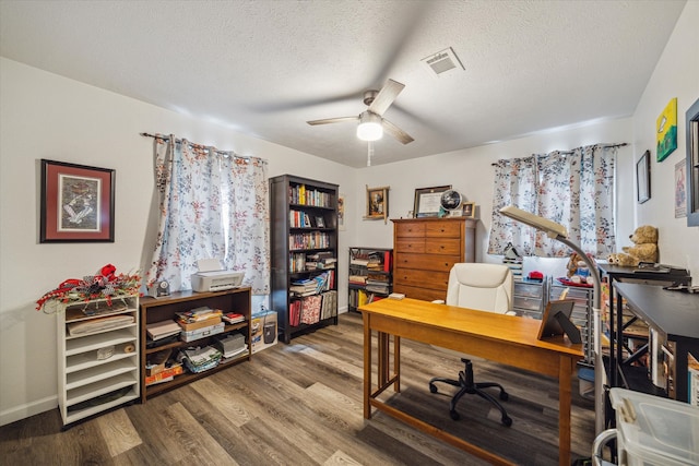 office space with a textured ceiling, hardwood / wood-style flooring, and ceiling fan