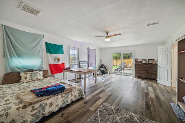 bedroom featuring access to outside, a textured ceiling, ceiling fan, and dark hardwood / wood-style flooring