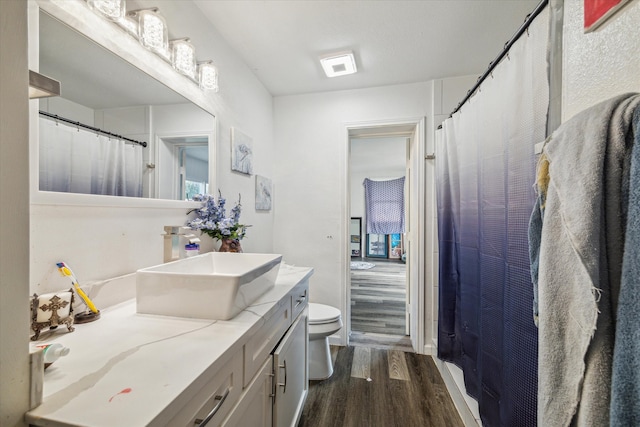 bathroom featuring vanity, hardwood / wood-style floors, and toilet