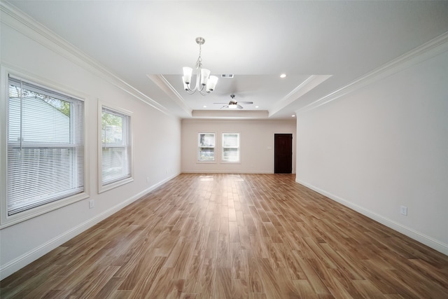 interior space with hardwood / wood-style flooring, ornamental molding, a raised ceiling, and ceiling fan with notable chandelier