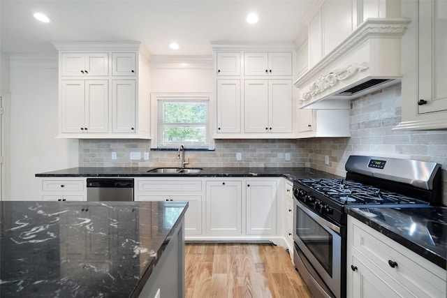 kitchen with white cabinetry, crown molding, appliances with stainless steel finishes, and sink