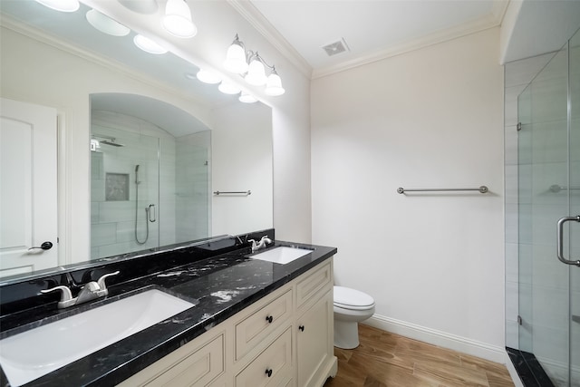 bathroom with vanity, wood-type flooring, toilet, and an enclosed shower