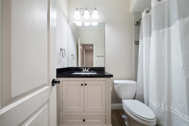 bathroom with vanity, toilet, hardwood / wood-style flooring, and walk in shower