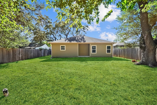 rear view of property with a lawn