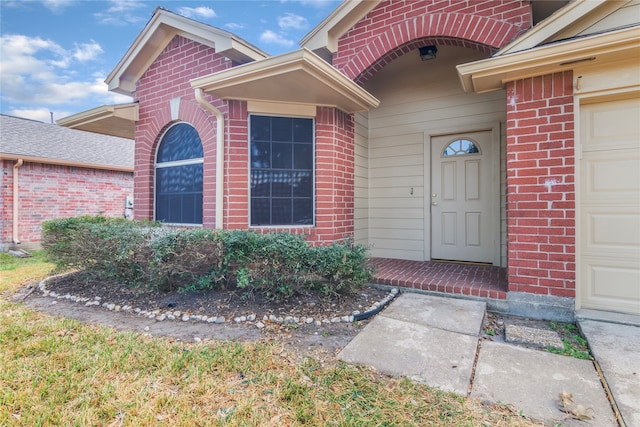 view of exterior entry with a garage