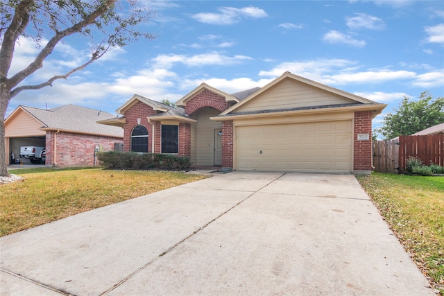 ranch-style house with a garage and a front lawn