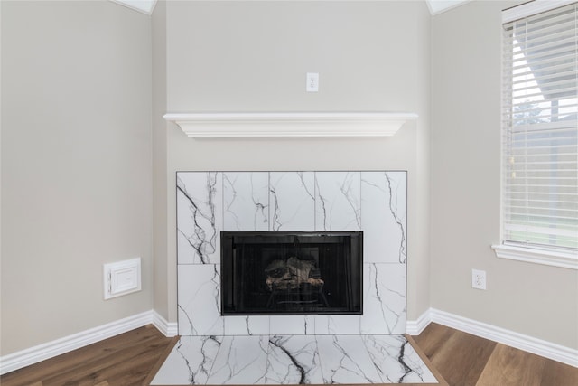 details featuring hardwood / wood-style flooring and a high end fireplace