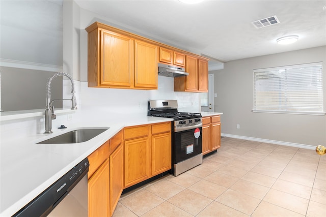 kitchen featuring tasteful backsplash, stainless steel appliances, sink, and light tile patterned floors