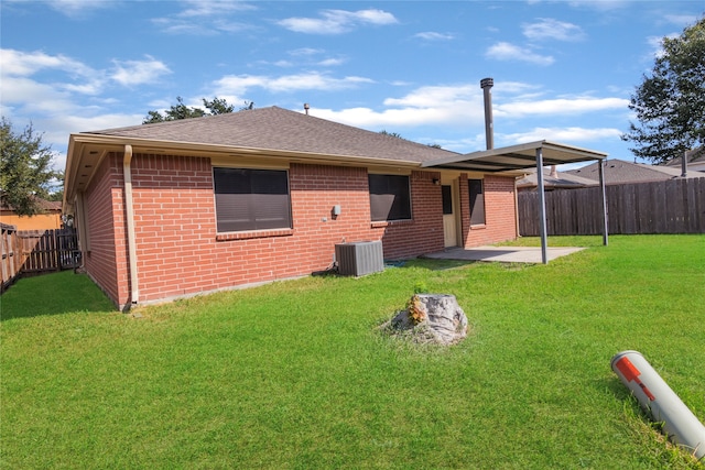 back of house featuring a patio, a lawn, and central AC unit