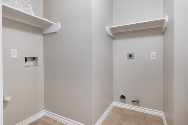 washroom featuring hookup for a gas dryer, hookup for an electric dryer, light tile patterned flooring, and hookup for a washing machine