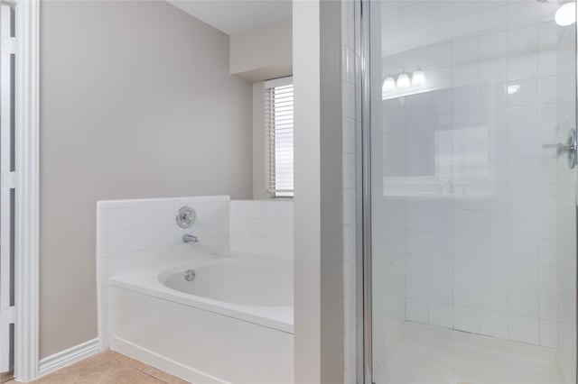 bathroom with independent shower and bath and tile patterned floors