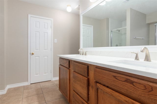 bathroom with vanity, a shower with shower door, and tile patterned flooring