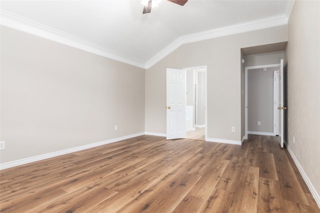 unfurnished bedroom with lofted ceiling, ornamental molding, hardwood / wood-style floors, and ceiling fan