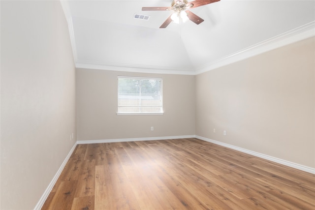 spare room featuring lofted ceiling, hardwood / wood-style flooring, ceiling fan, and crown molding