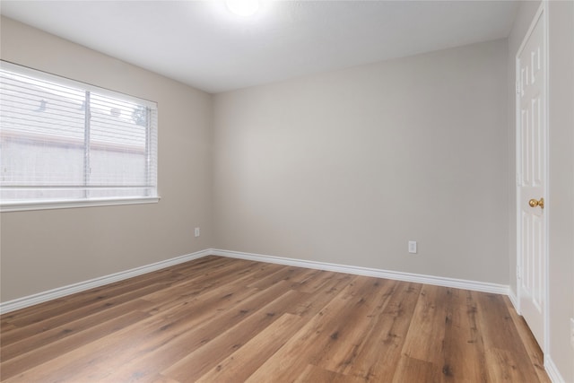 spare room featuring wood-type flooring