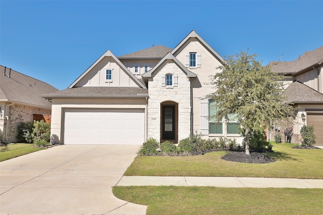 view of front of home with a front lawn and a garage