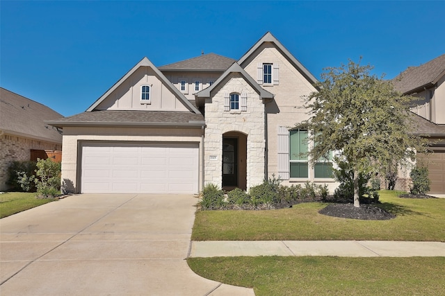 view of front of property featuring a front yard and a garage