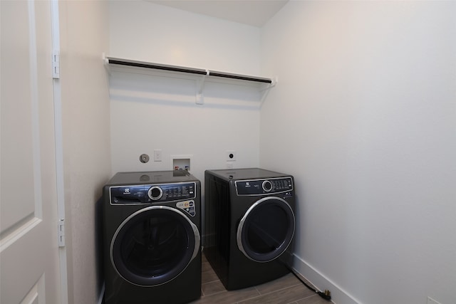 washroom with wood-type flooring and separate washer and dryer