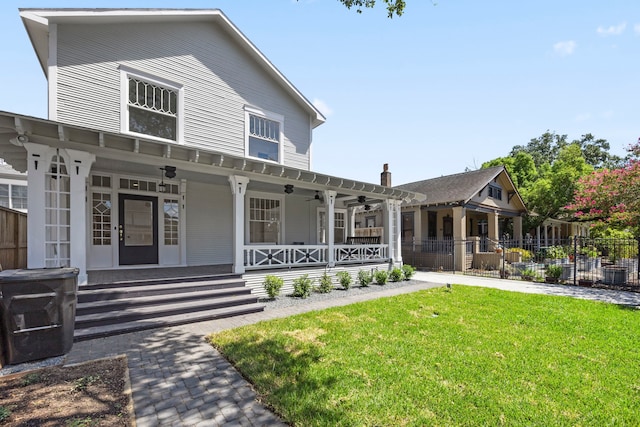 view of front of home with a front yard and covered porch