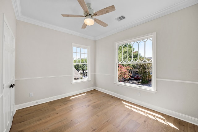 spare room with crown molding, hardwood / wood-style flooring, and ceiling fan