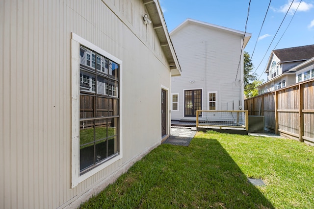 rear view of property with a deck and a lawn