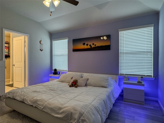 bedroom featuring ceiling fan, wood-type flooring, and lofted ceiling