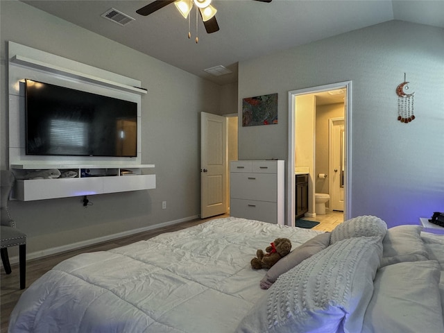 18310 Grayson Bluff Way, Richmond, TX 77407 - bedroom with wood finished floors, connected bathroom, lofted ceiling, and a ceiling fan