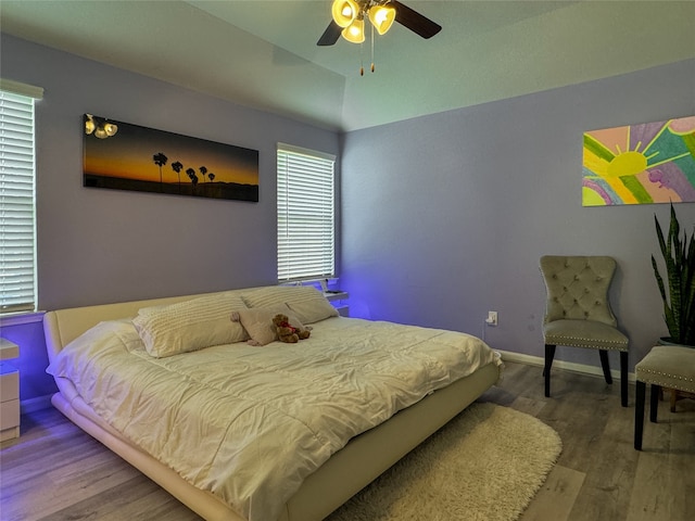 bedroom with ceiling fan and hardwood / wood-style flooring