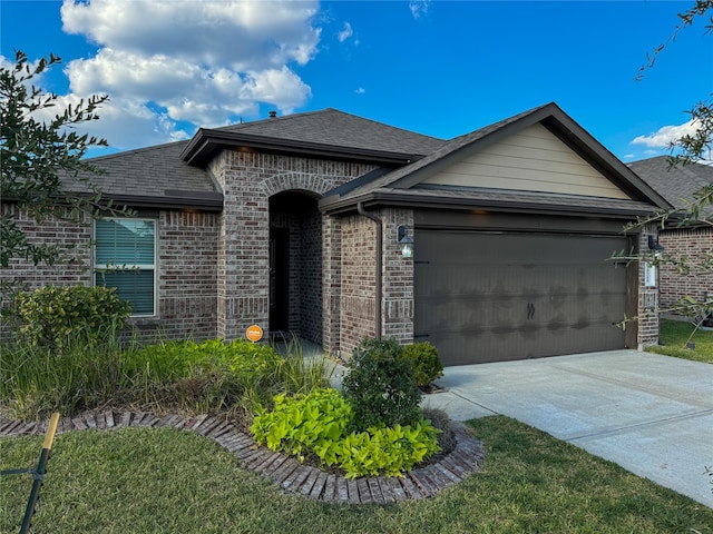 view of front of property with a front yard and a garage