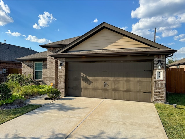 18310 Grayson Bluff Way, Richmond, TX 77407 - view of front facade featuring fence, brick siding, an attached garage, concrete driveway, and a shingled roof