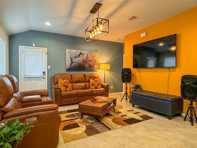 living room with a notable chandelier and vaulted ceiling