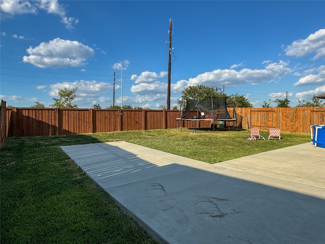 view of yard with a patio area and a trampoline