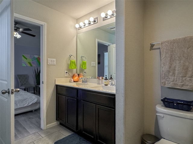 bathroom featuring vanity, toilet, wood-type flooring, and ceiling fan