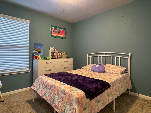 carpeted bedroom featuring multiple windows and a textured ceiling