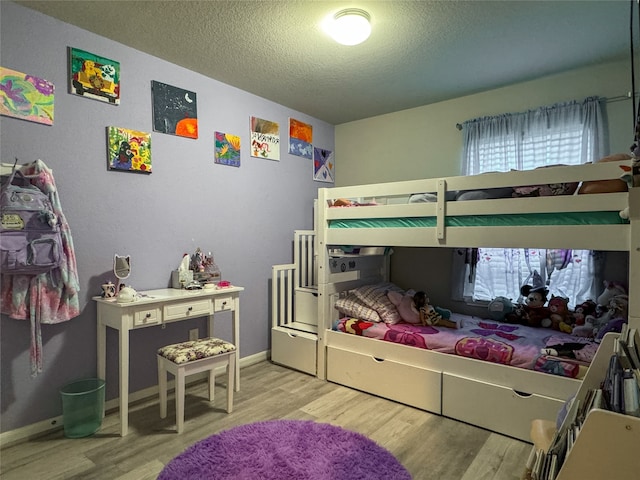 bedroom featuring wood-type flooring and a textured ceiling