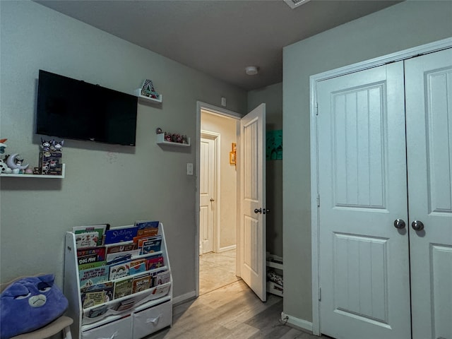 bedroom with a closet and light hardwood / wood-style flooring