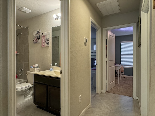 full bathroom featuring vanity, tiled shower / bath combo, toilet, and tile patterned floors