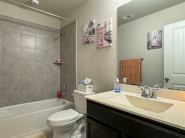 full bathroom with vanity, toilet, and tiled shower / bath combo