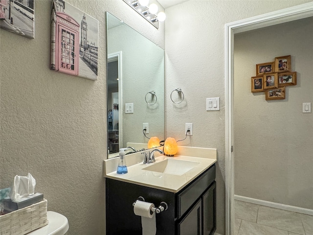 bathroom featuring vanity, toilet, and tile patterned flooring