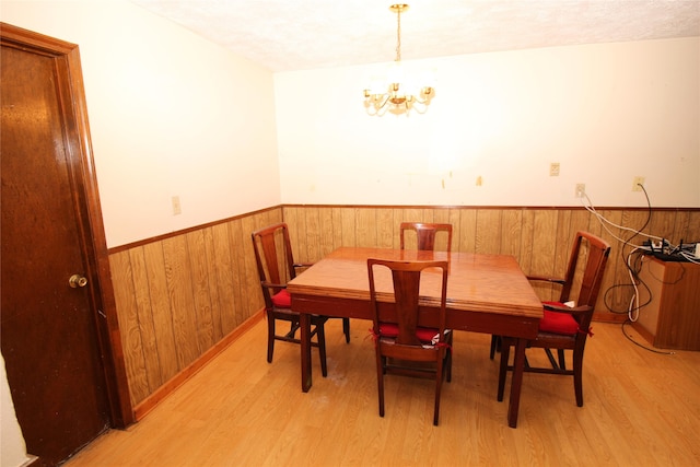 dining space with a chandelier and light wood-type flooring