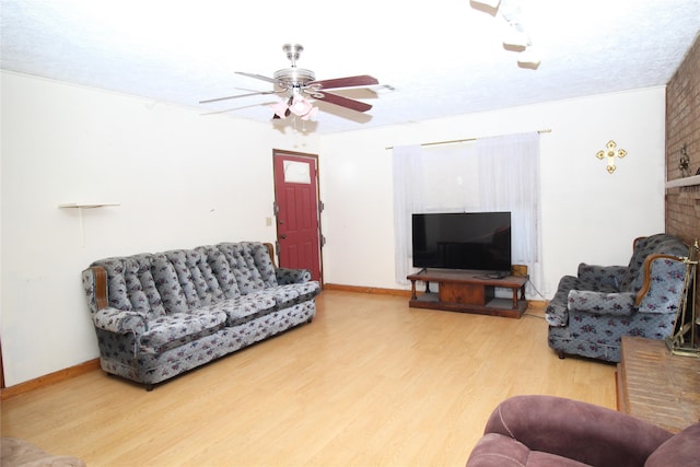 living room with ceiling fan and wood-type flooring