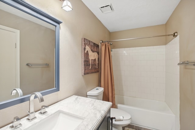 full bathroom with vanity, shower / tub combo, and toilet