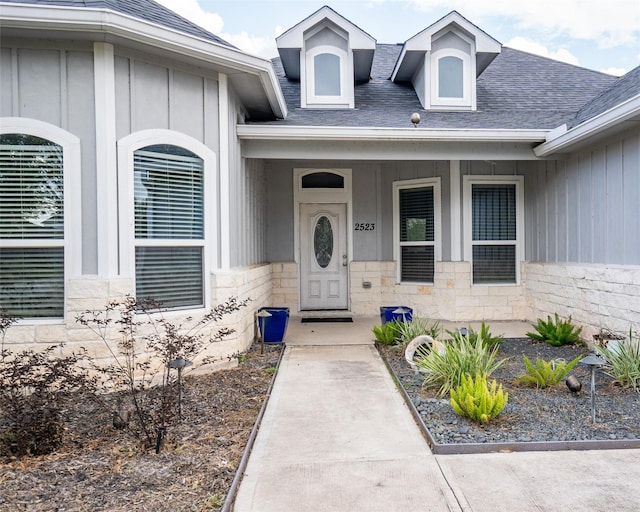 2523 Turberry Dr, West Columbia, TX 77486 - property entrance featuring board and batten siding, roof with shingles, a porch, and stone siding