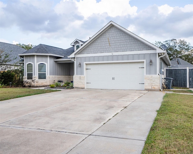 2523 Turberry Dr, West Columbia, TX 77486 - view of front of home with stone siding, board and batten siding, concrete driveway, a garage, and a shingled roof