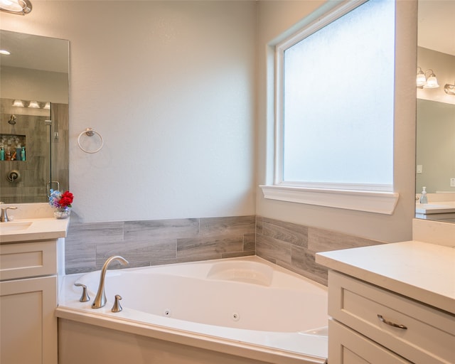 bathroom with plus walk in shower and vanity