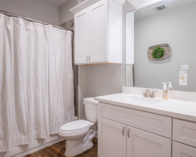 full bathroom with toilet, vanity, hardwood / wood-style floors, and shower / bath combo with shower curtain