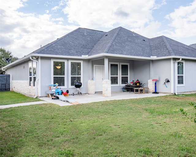 back of property featuring a patio and a lawn