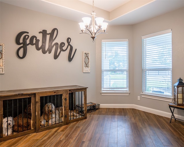 interior space with dark hardwood / wood-style flooring and a notable chandelier