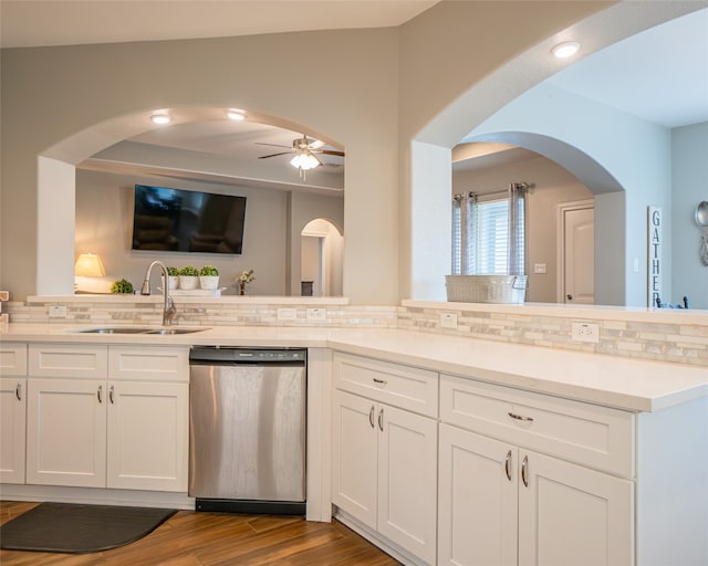 kitchen with dishwasher, decorative backsplash, hardwood / wood-style flooring, and white cabinets