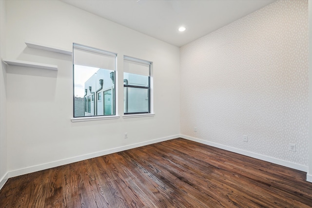 empty room with dark hardwood / wood-style floors